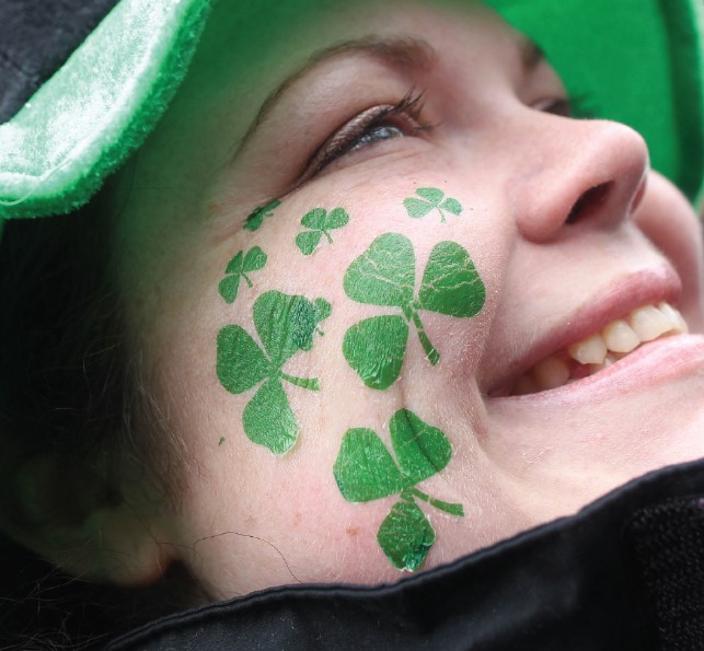 Person with Shamrock tattoos on her face
