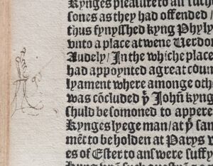 Detail from the page of a 16th century book with a hand-drawn 'manicule' pointing at a section of printed text