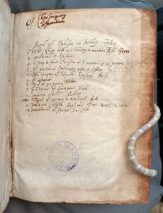Table of contents written in ink on the front of a 17th century book.